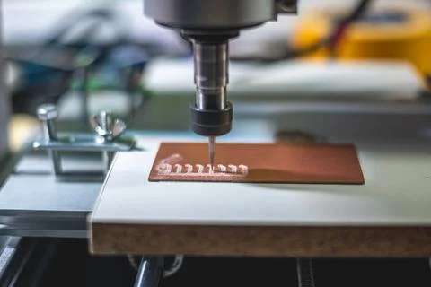 Machine with numerical control CNC carries out milling of printed circuit boa Stock Photos