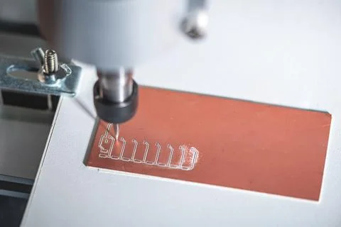 Machine with numerical control CNC carries out milling of printed circuit boa Stock Photos