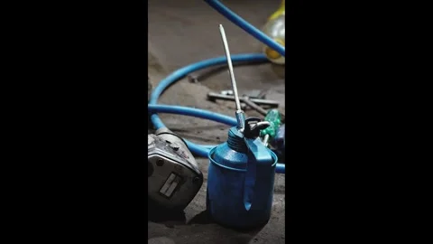 Machine Oil Can with Hoses in Workshop Setup Stock Footage 316579061