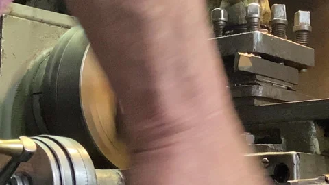 The machine is in operation. Sharpening a part made of brass metal Stock Footage 243260572