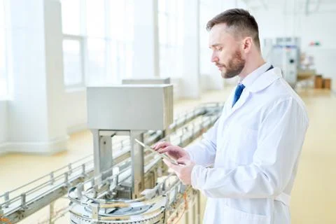 Machine Operator Concentrated on Work Stock Photos
