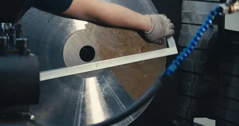 The machine operator measures the diameter of parts made of brass material with Video stock 170600321