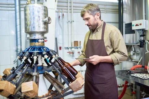 Machine Operator at Modern Brewery Stock Photos