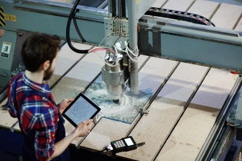 Machine Operator Using Glass Cutter in Shop Stock Photos