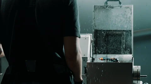 Machine Operator at Work with Coolant Spray in Industrial Workshop Stock Footage 337927373