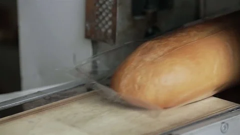 Machine packs fresh bread in the transparent film Stock Footage 76017050