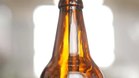 The machine places a bottle under the nozzle to fill it with beer. Stock Footage 113523599