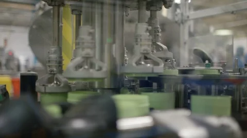 Machine placing lids on cosmetic boxes on production line in factory Stock Footage 107960408
