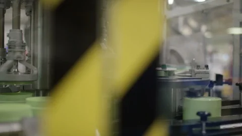 Machine placing lids on cosmetic boxes on production line in factory Stock Footage 107960651