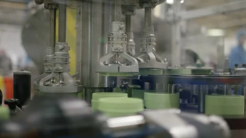 Machine placing lids on cosmetic boxes on production line in factory Stock Footage 107961307
