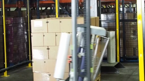 Machine. Plastic wrapping boxes for transport B Stock Footage 102185672