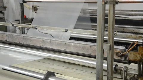 Machine with polyethylene for the production of plastic bags	 Video stock 123062624