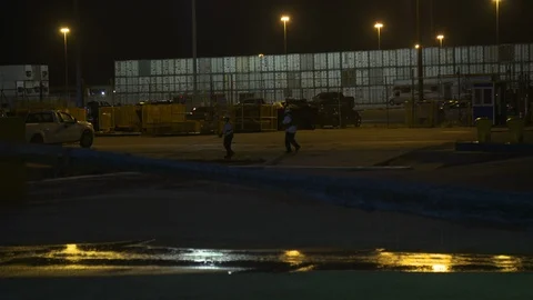Machine positioning heavy rope or tube in dark at Terminal 25 in night Stock Footage 116416542