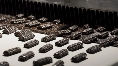 Machine pouring liquid on candies. Stock Footage 123862484
