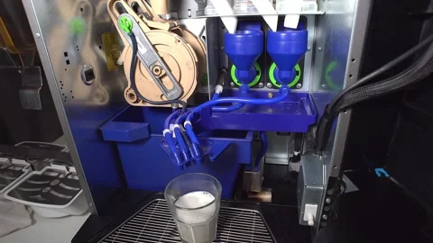 The machine prepares a cappuccino with milk and strong coffee from a coffee tabl Stock Footage 227294275