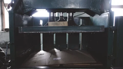 Machine presses cardboard in a factory Stock Footage 105371586