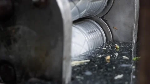 A machine presses fresh juice from sugarcane stalks at a local outdoor market. B Stock Footage 338001343