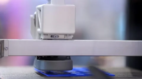 Machine prints blue plastic layer on flat surface Stock Footage 345701043