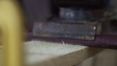 The machine for processing wood slides on a wooden beam, the machine moves along Stock Footage 94066454