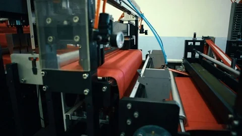 A machine is producing red fabric Video stock 73714504