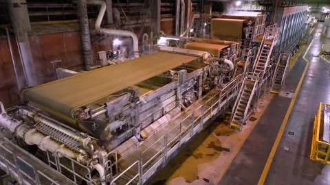 A machine for the production and packaging of cellulose sheets. Paper production Stockbeeldmateriaal 301960901