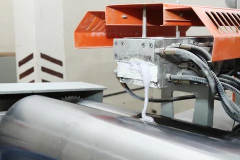 Machine for the production of powder paint. A layer of plastic is cut, crushe Stock Photos