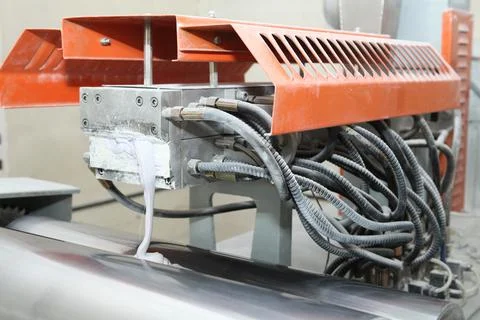 Machine for the production of powder paint. A layer of plastic is cut, crushe Stock Photos
