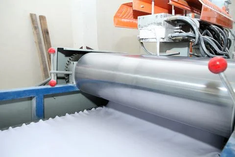 Machine for the production of powder paint. A layer of plastic is cut, crushe Stock Photos