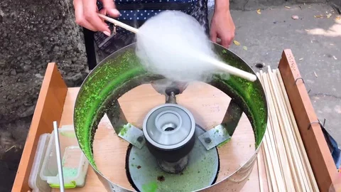 Machine for the production of sweet cotton candy on a stick Stock Footage 96249993