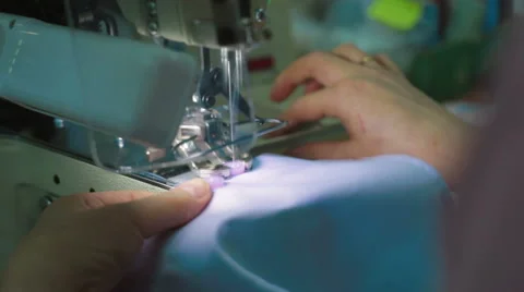 Machine pulling sewing on buttons to shirt Stock Footage 62351524