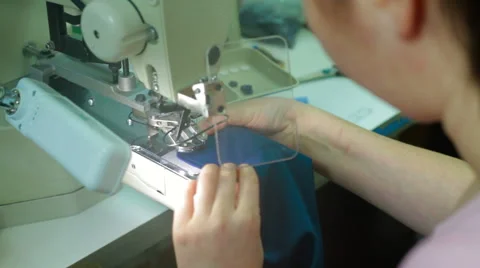 Machine pulling sewing on buttons to shirt Stock Footage 62355971