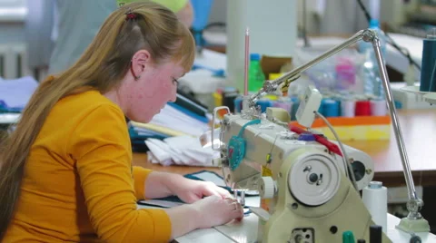 Machine pulling sewing woman working with textile Stock Footage 62349987