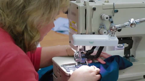 Machine pulling sewing woman working with textile Stock Footage 62351072