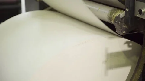 Machine pulls and twists large paper roll in printing house Stock Footage 71312931