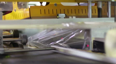 Machine puts shrink-wrap to bottles Stock-Footage 22554922