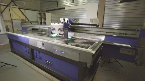 Machine quickly applies the drawing to the canvas on the printer Video stock 105369486
