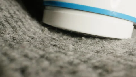 Machine for removing pellets close-up. Wool textile cloth texture close-up macro Stock Footage 260414955