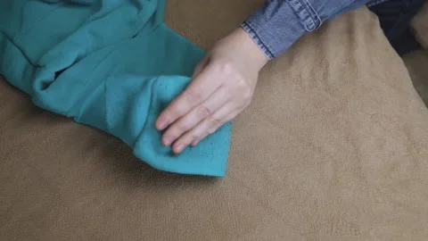 Machine for removing pellets. The girl uses a special device to remove lint from Stock Footage 228963742