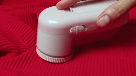 Machine for removing pellets from a pink jacket. Stock Footage 305852941