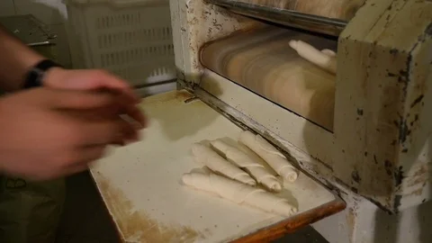 Machine rolling bread Stock Footage 76194584