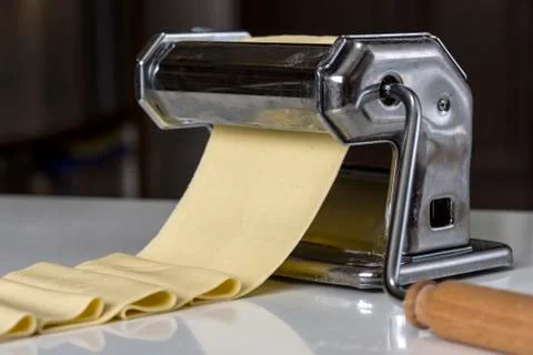 Machine for rolling dough and cutting Italian pasta noodles Stock Photos