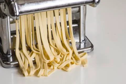 Machine for rolling dough and cutting Italian pasta noodles Stock Photos