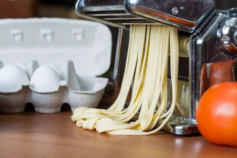 Machine for rolling dough and cutting Italian pasta, eggs and flour Stock Photos