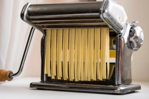 Machine for rolling dough and cutting Italian pasta noodles Stock Photos