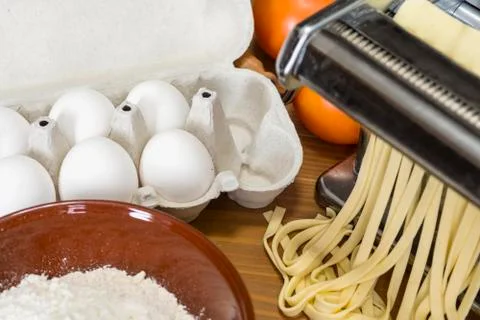 Machine for rolling dough and cutting Italian pasta, eggs and flour Stock Photos