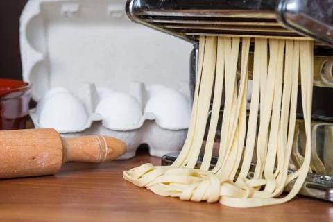 Machine for rolling dough and cutting Italian pasta, eggs and flour Stock Photos