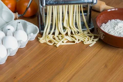 Machine for rolling dough and cutting Italian pasta, eggs and flour Stock Photos
