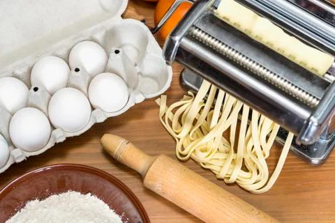 Machine for rolling dough and cutting Italian pasta, eggs and flour Stock Photos