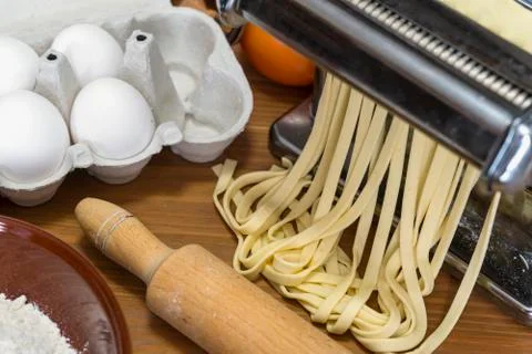 Machine for rolling dough and cutting Italian pasta, eggs and flour Stock Photos
