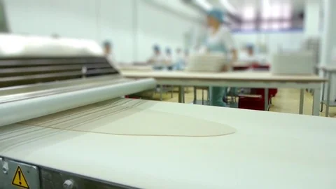 Machine rolls the dough and cuts it work Stock Footage 69991605